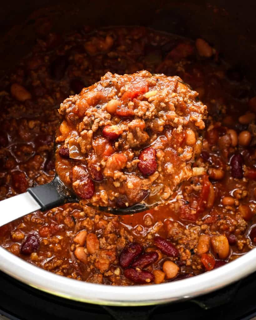 A ladle full of instant pot chili over the rest of the pot.