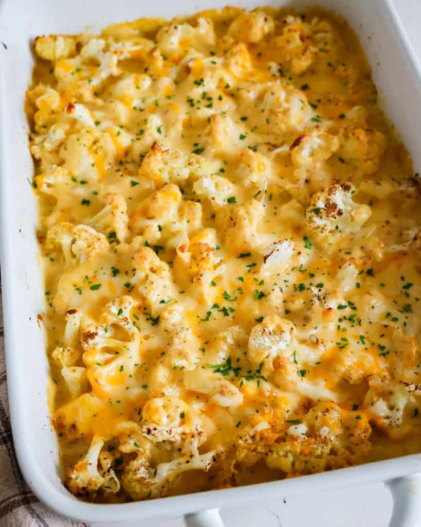 A 9x13-inch casserole dish full of baked cauliflower mac and cheese. 
