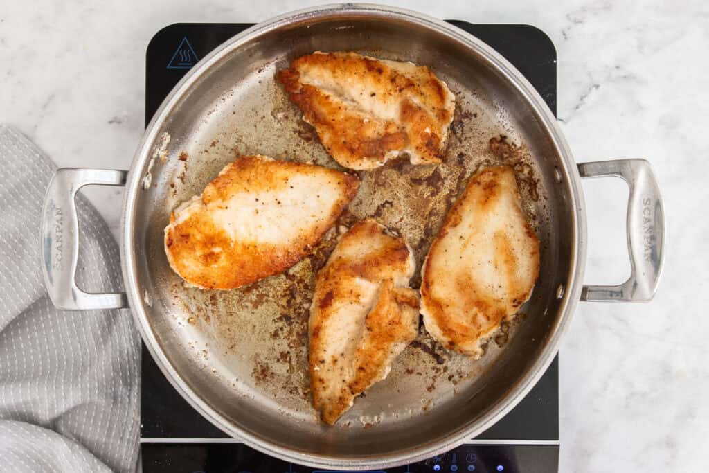 Some of the steps for making chicken florentine. Heat a little butter and olive oil in a large skillet over medium-high heat. Add the chicken and cook until golden brown and cooked through. 