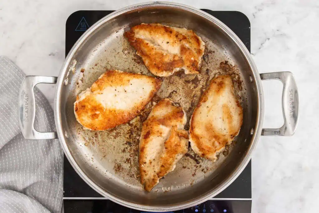 Some of the steps for making chicken florentine. Heat a little butter and olive oil in a large skillet over medium-high heat. Add the chicken and cook until golden brown and cooked through.