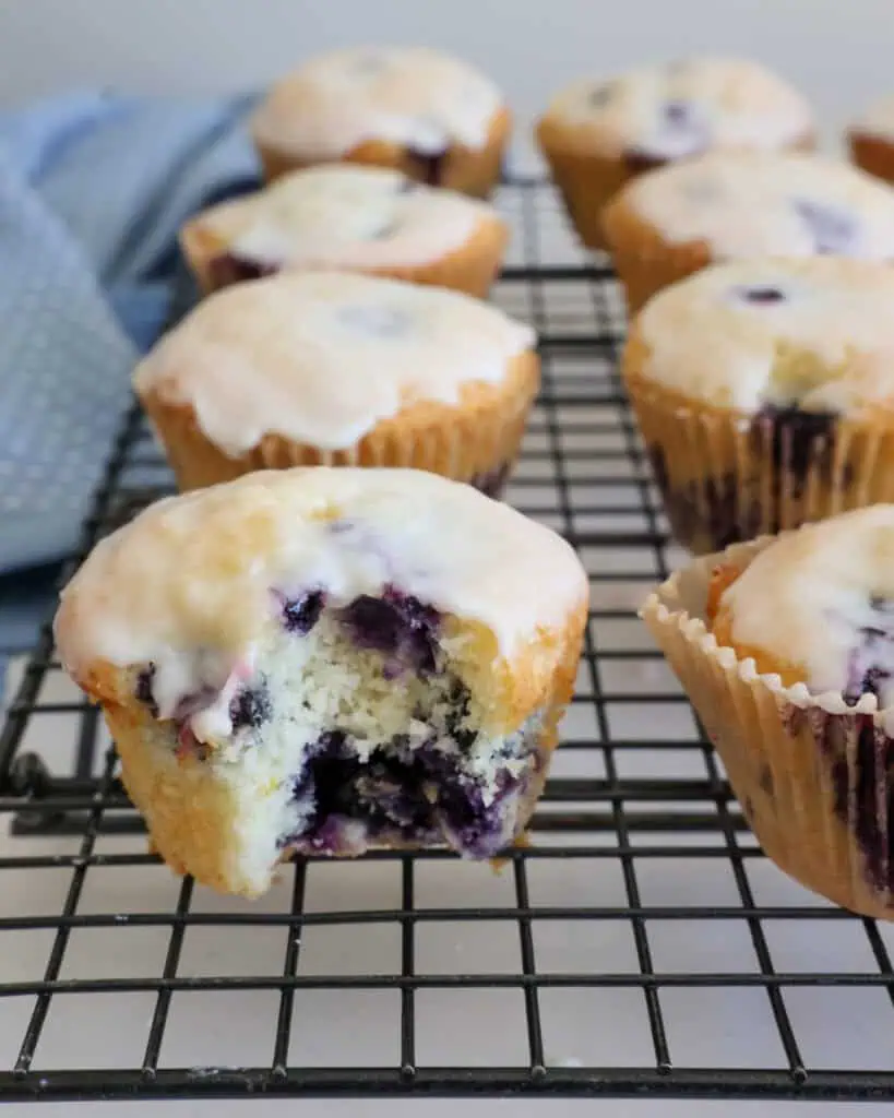 A close up view of the inside of a lemon blueberry muffins with lemon glaze. 