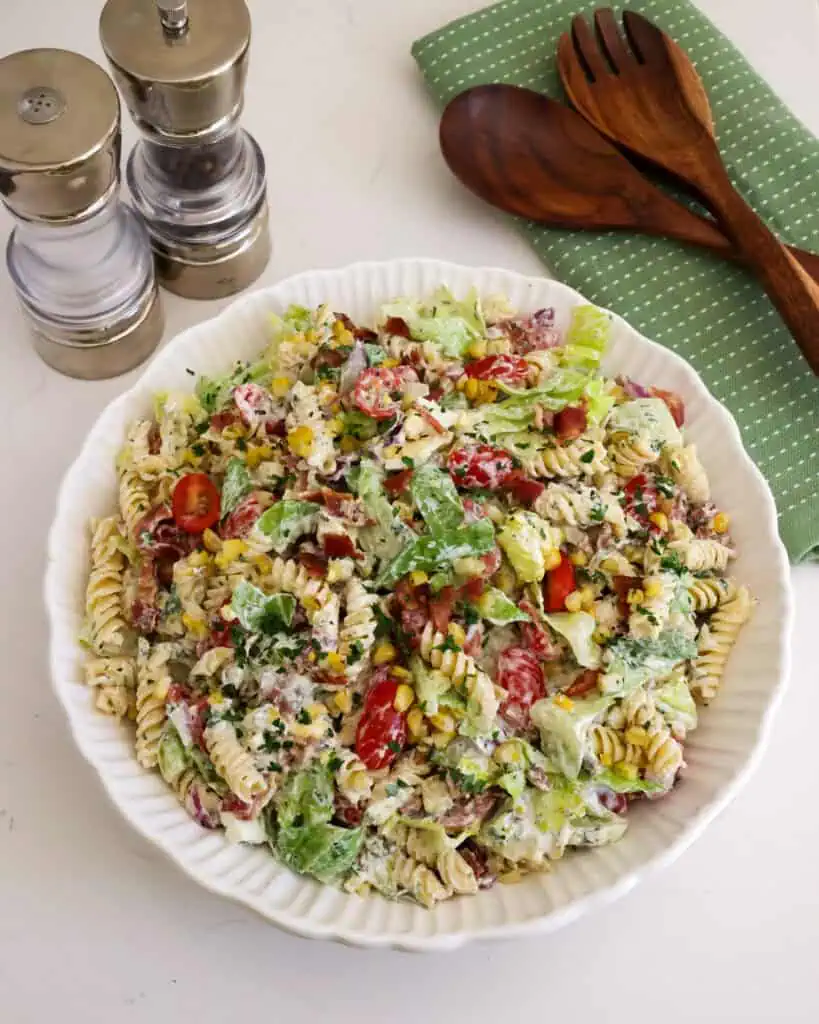 An overhead view of BLT pasta salad in large white serving bowl. 