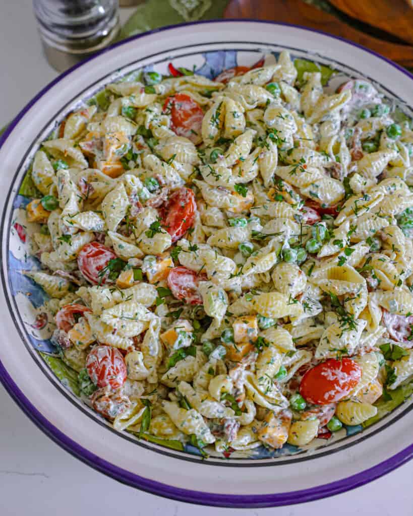 A close up view of bacon ranch pasta salad in a large wide bowl. 