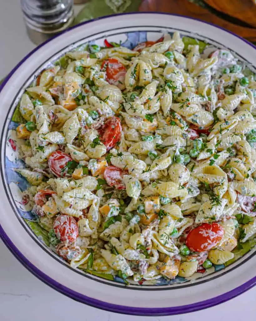 A close up view of bacon ranch pasta salad in a large wide bowl. 