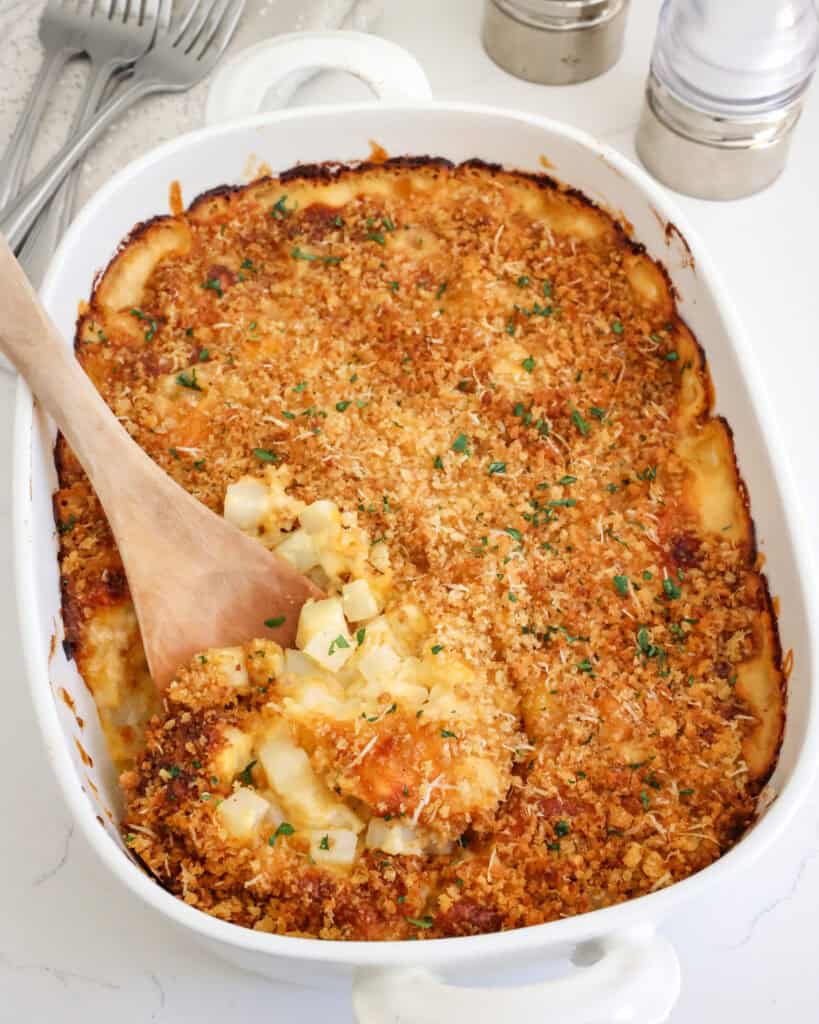 An overhead view of a casserole dish full of cheesy potatoes. 