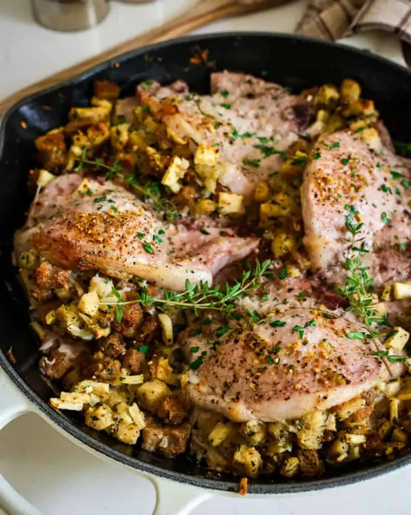 An overhead view of pork chops stuffed with an apple, onion, and herb stuffing. 