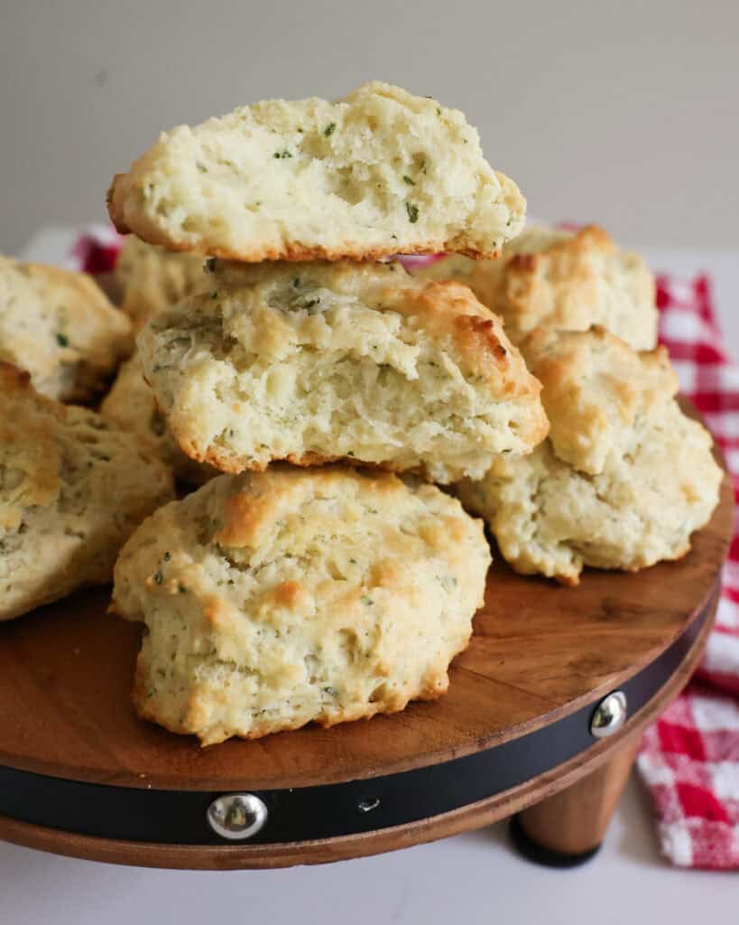 Drop biscuits with fresh herbs on a wooden serving board. 