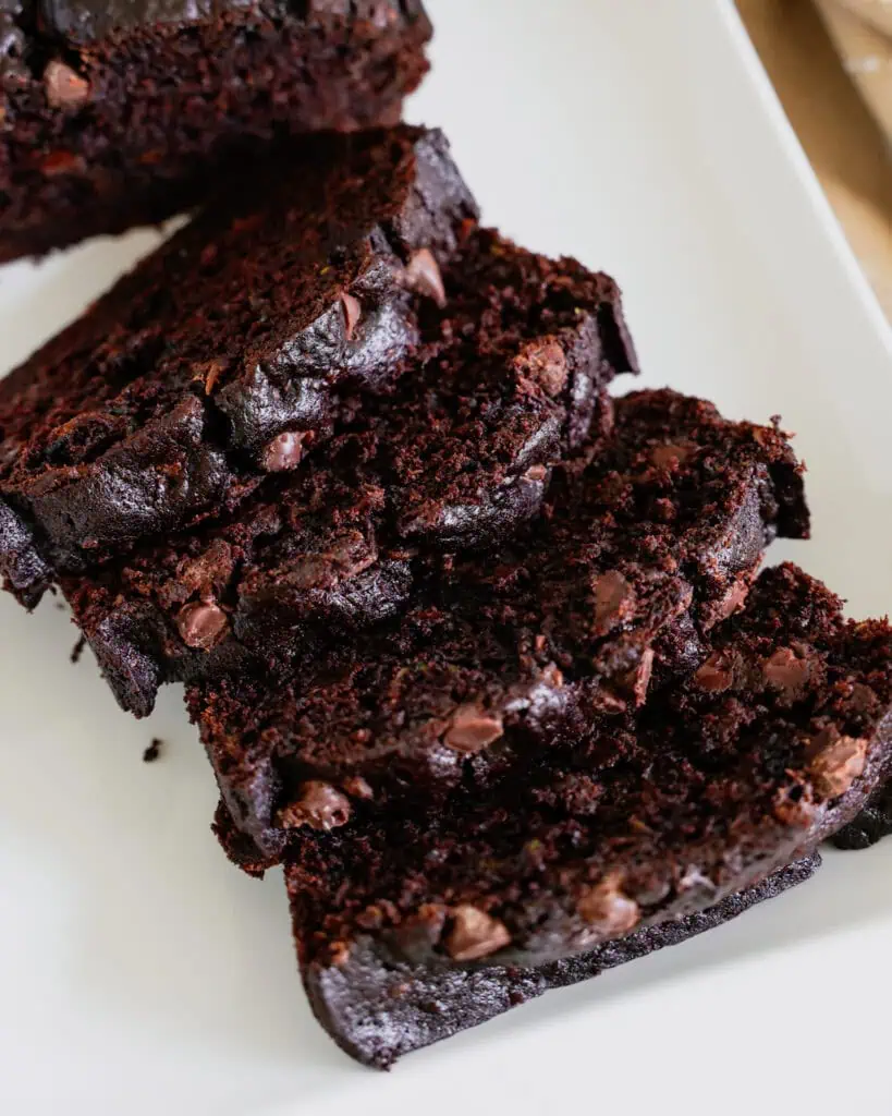 An overhead view of chocolate zucchini bread on a white platter. 