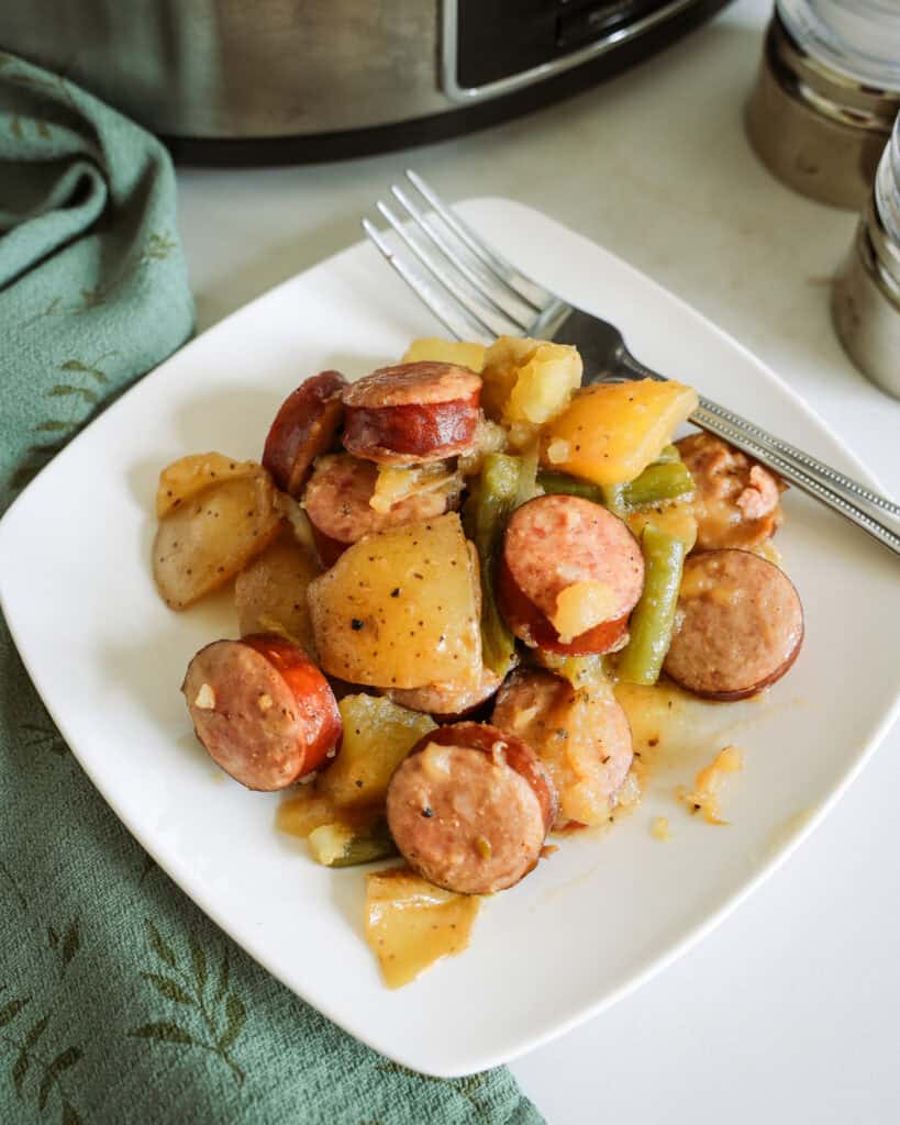 Swamp potatoes on a single serving plate with a fork.