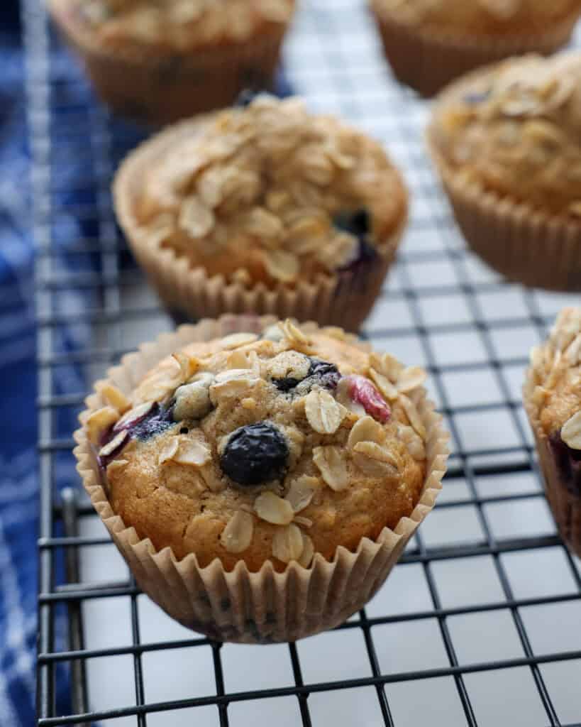 A close up view of blueberry oatmeal muffins on a cooling rack. 
