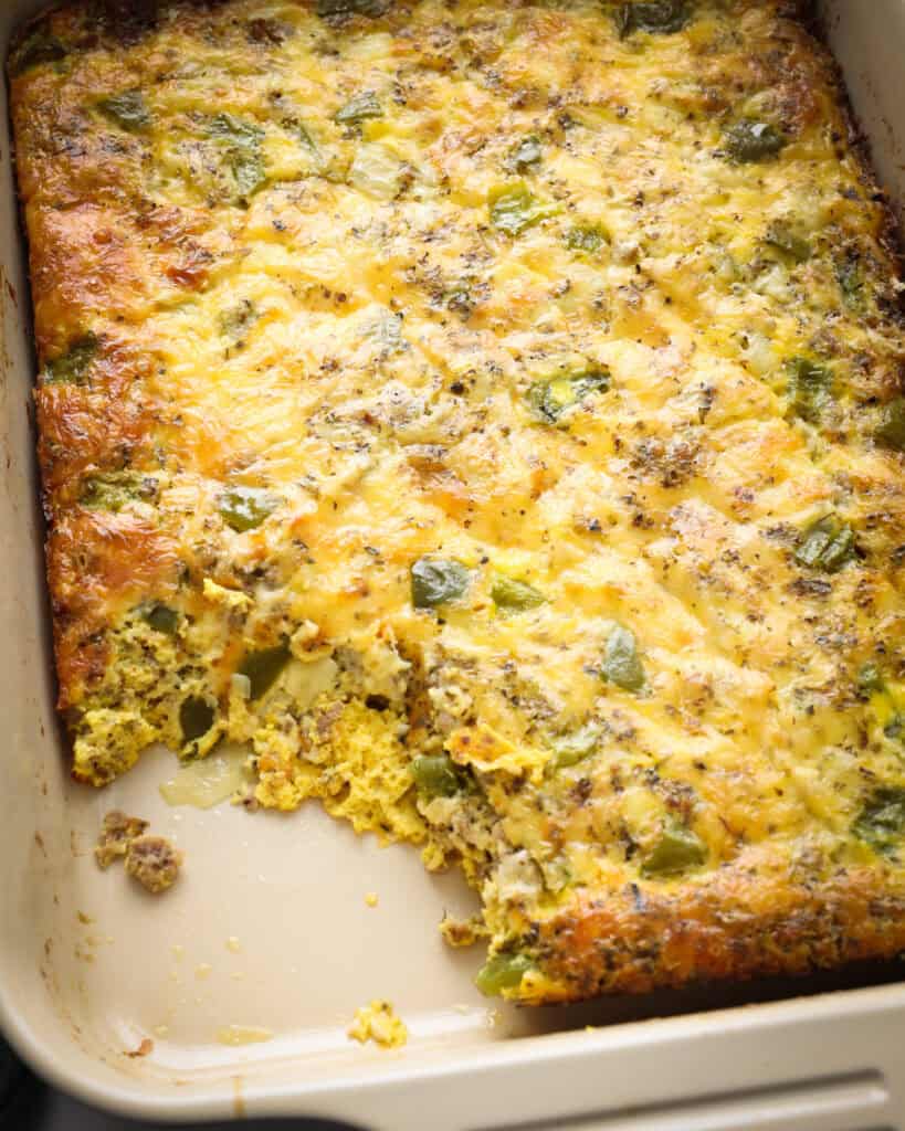 An overhead view of sausage, egg, and cheese casserole with green bell peppers. 