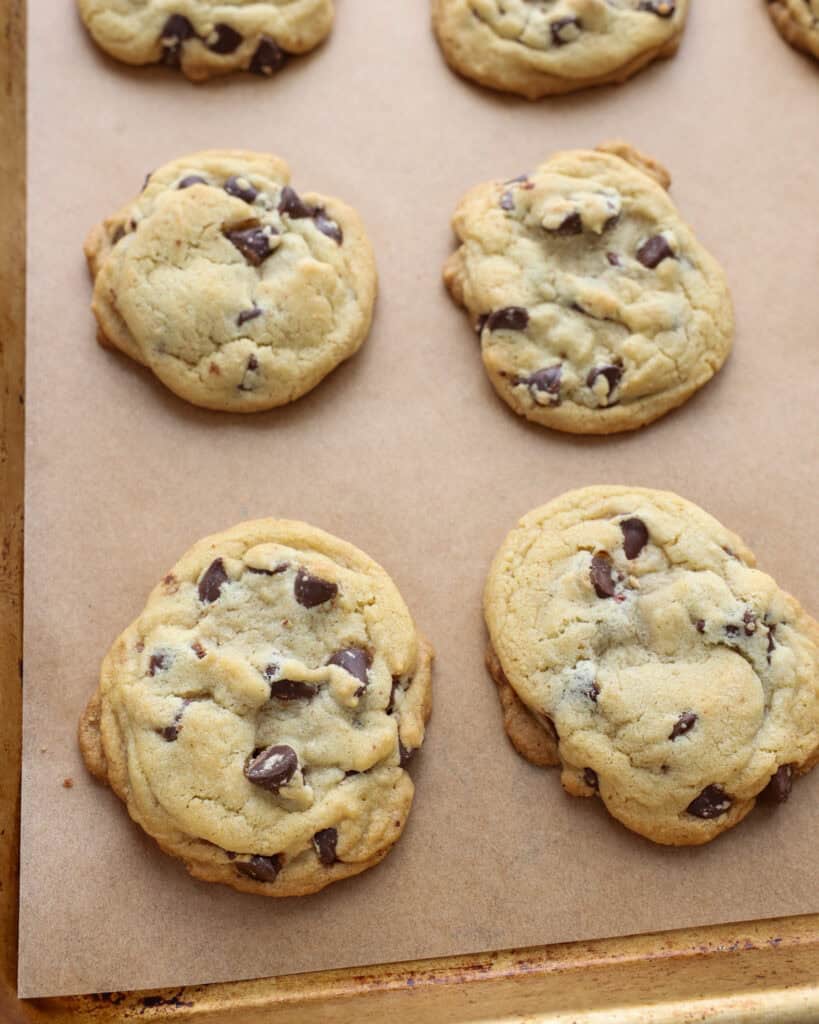 Brown butter chocolate chip cookies on a baking sheet covered with parchment paper. 