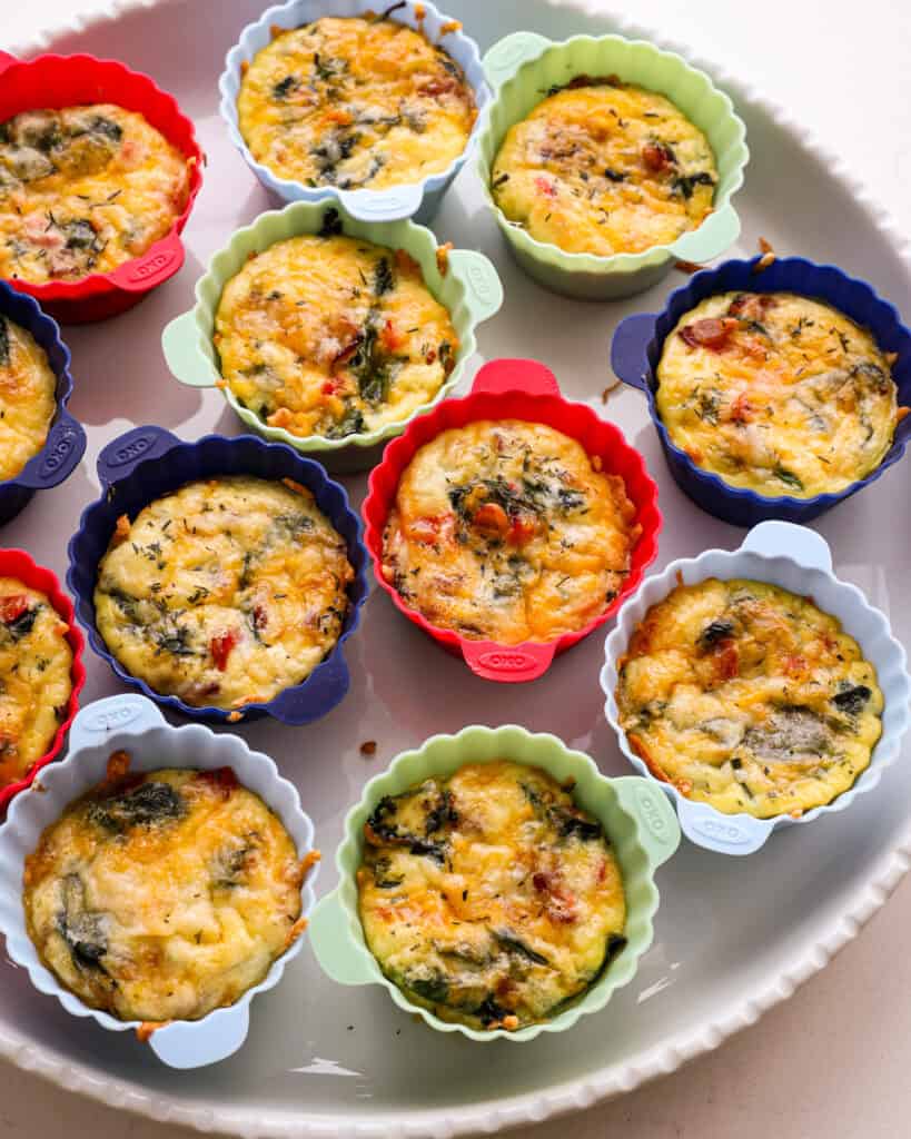 Egg bites on a white serving platter. 