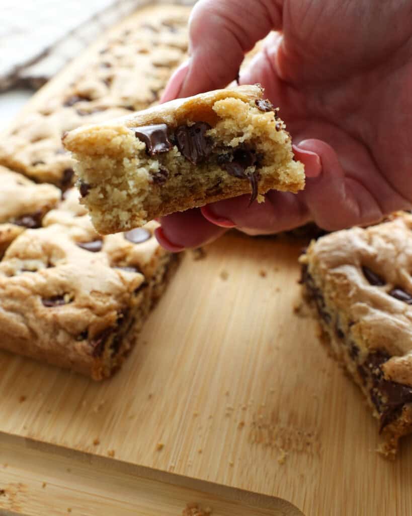 A close up view of the inside of a chocolate chip cookie bar.