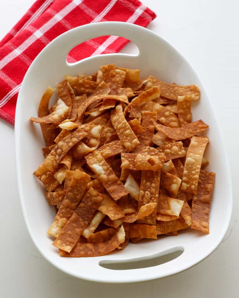 A big white bowl full of fried wonton strips.