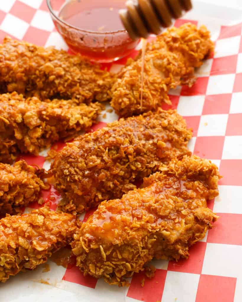 Breaded chicken with hot honey sauce drizzled on it. 