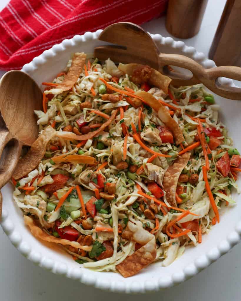 An overhead view of Thai chicken salad with cabbage. bell peppers, peanuts, and cilantro.