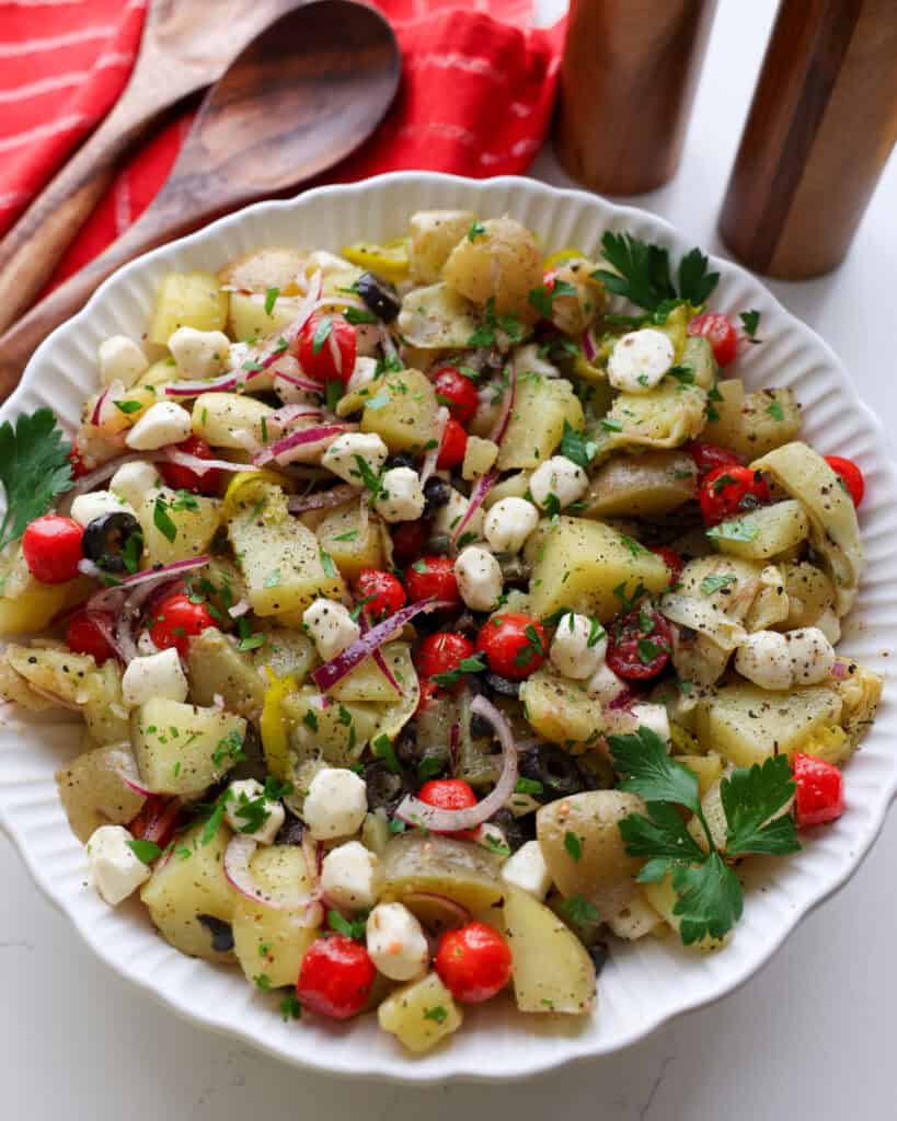 An Italian potato salad with mozzarella pearls, artichoke hearts, and capers.